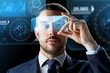 Image showing businessman with smartphone and virtual holograms