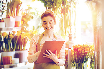 Image showing florist woman with clipboard at flower shop