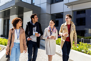 Image showing people with coffee and conference badges in city