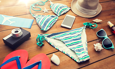 Image showing close up of smartphone and beach stuff