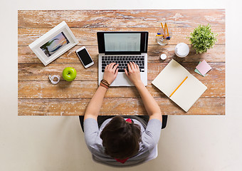 Image showing woman with receipt on laptop screen at office