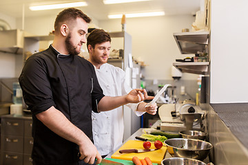 Image showing two chefs cooking food at restaurant kitchen