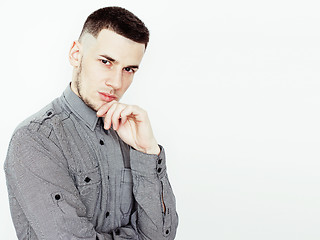 Image showing young handsome teenage hipster guy posing emotional, happy smiling against white background isolated, lifestyle people concept 