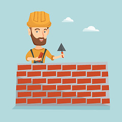 Image showing Bricklayer working with spatula and brick.