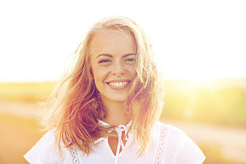 Image showing close up of happy young woman in white outdoors
