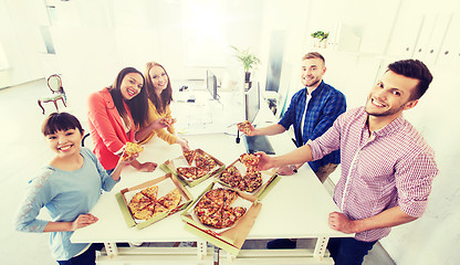 Image showing happy business team eating pizza in office