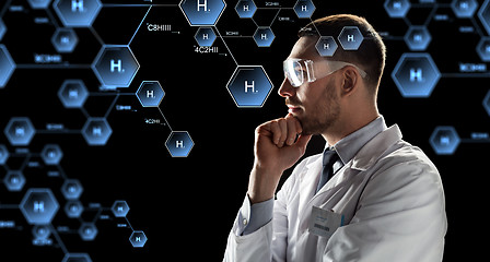 Image showing scientist in goggles looking at chemical formula