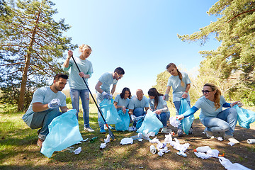 Image showing volunteers with garbage bags cleaning park area