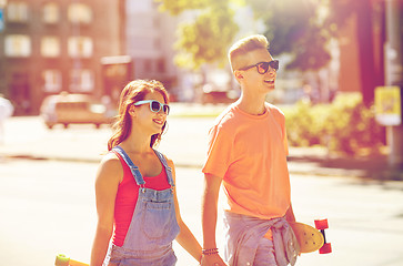 Image showing teenage couple with skateboards on city street