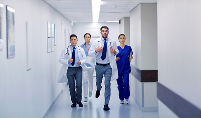 Image showing group of medics walking along hospital