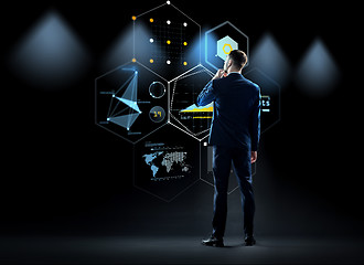 Image showing businessman looking at virtual screen from back