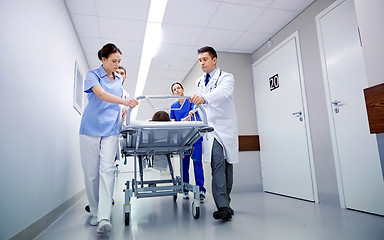 Image showing medics and patient on hospital gurney at emergency