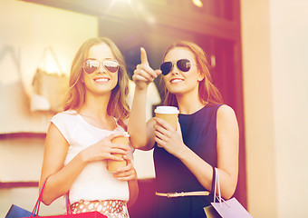 Image showing young women with shopping bags and coffee at shop