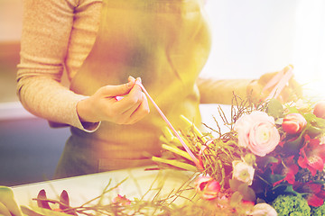 Image showing close up of woman making bunch at flower shop