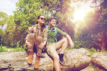 Image showing smiling couple with backpacks in nature