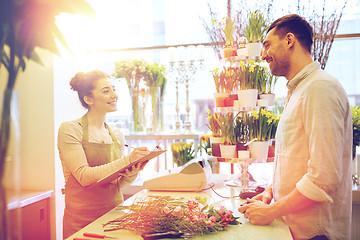 Image showing florist woman and man making order at flower shop