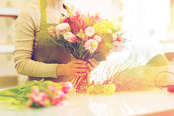 Image showing close up of woman making bunch at flower shop