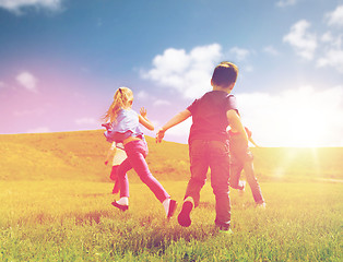 Image showing group of happy kids running outdoors