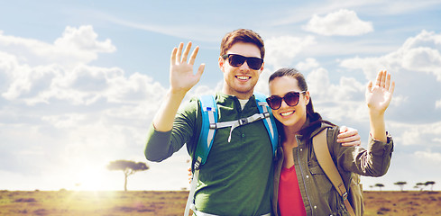 Image showing smiling couple with backpacks traveling in africa