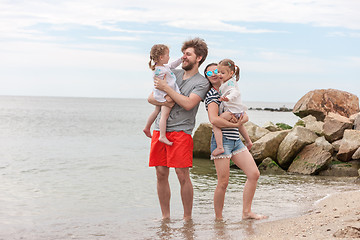 Image showing Family vacation parents and children on the sea shore summer day