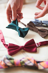 Image showing The male hand choosing hand made bow ties