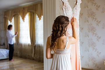 Image showing Bride hugging wedding dress