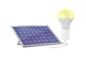 Image showing Solar panel and glowing light bulb