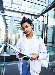 Image showing young cute indian girl at university building sitting on stairs 