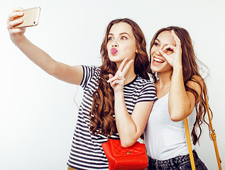 Image showing best friends teenage girls together having fun, posing emotional on white background, besties happy smiling, lifestyle people concept close up. making selfie