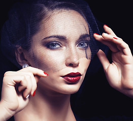 Image showing beauty brunette woman under black veil with red manicure close u