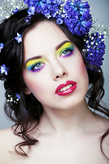 Image showing Beauty young woman with flowers and make up close up, real sprin