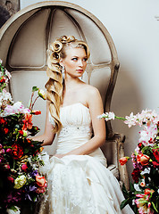 Image showing beauty young blond woman bride alone in luxury vintage interior with a lot of flowers 