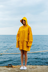 Image showing Girl wearing yellow raincoat