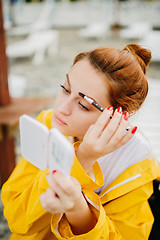 Image showing Woman doing makeup outside