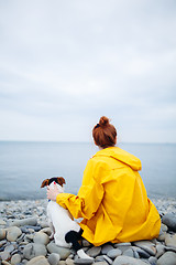 Image showing Woman with dog on coast