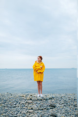 Image showing Girl wearing yellow raincoat