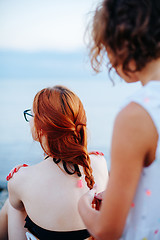 Image showing Woman braiding girl on beach