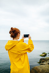 Image showing Girl taking photo of ocean