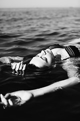 Image showing Woman floating on water