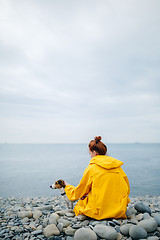 Image showing Woman with dog on coast