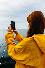 Image showing Girl taking photo of ocean