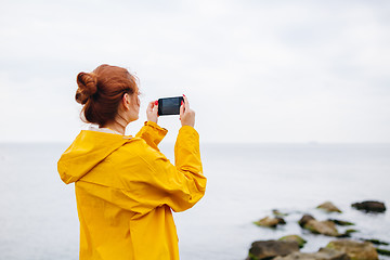 Image showing Girl taking photo of ocean