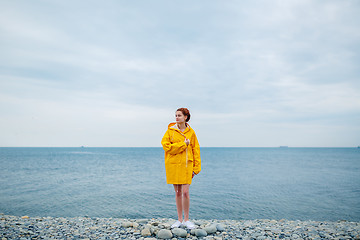 Image showing Girl wearing yellow raincoat