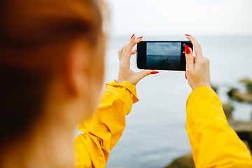 Image showing Girl taking photo of ocean