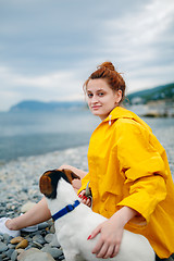 Image showing Girl with dog on beach