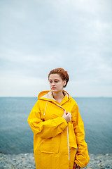 Image showing Girl wearing yellow raincoat