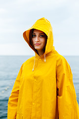 Image showing Girl wearing yellow raincoat