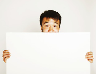 Image showing pretty cool asian man holding empty white plate smiling