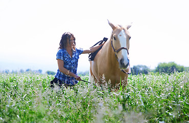 Image showing Woman training her horse