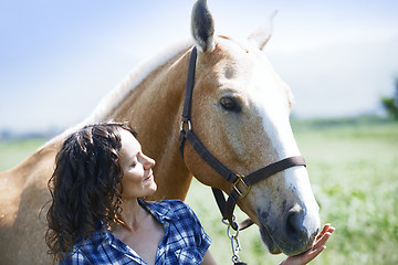 Image showing Woman and horse together at paddock